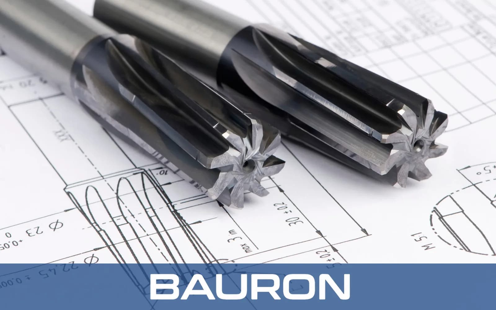 Carbide reamers resting on a technical drawing